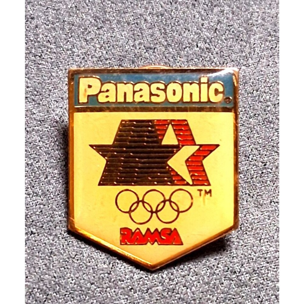 Vintage Panasonic LA 84 Olympics RAMSA Shield Enamel Lapel Pin Badge Gold Tone